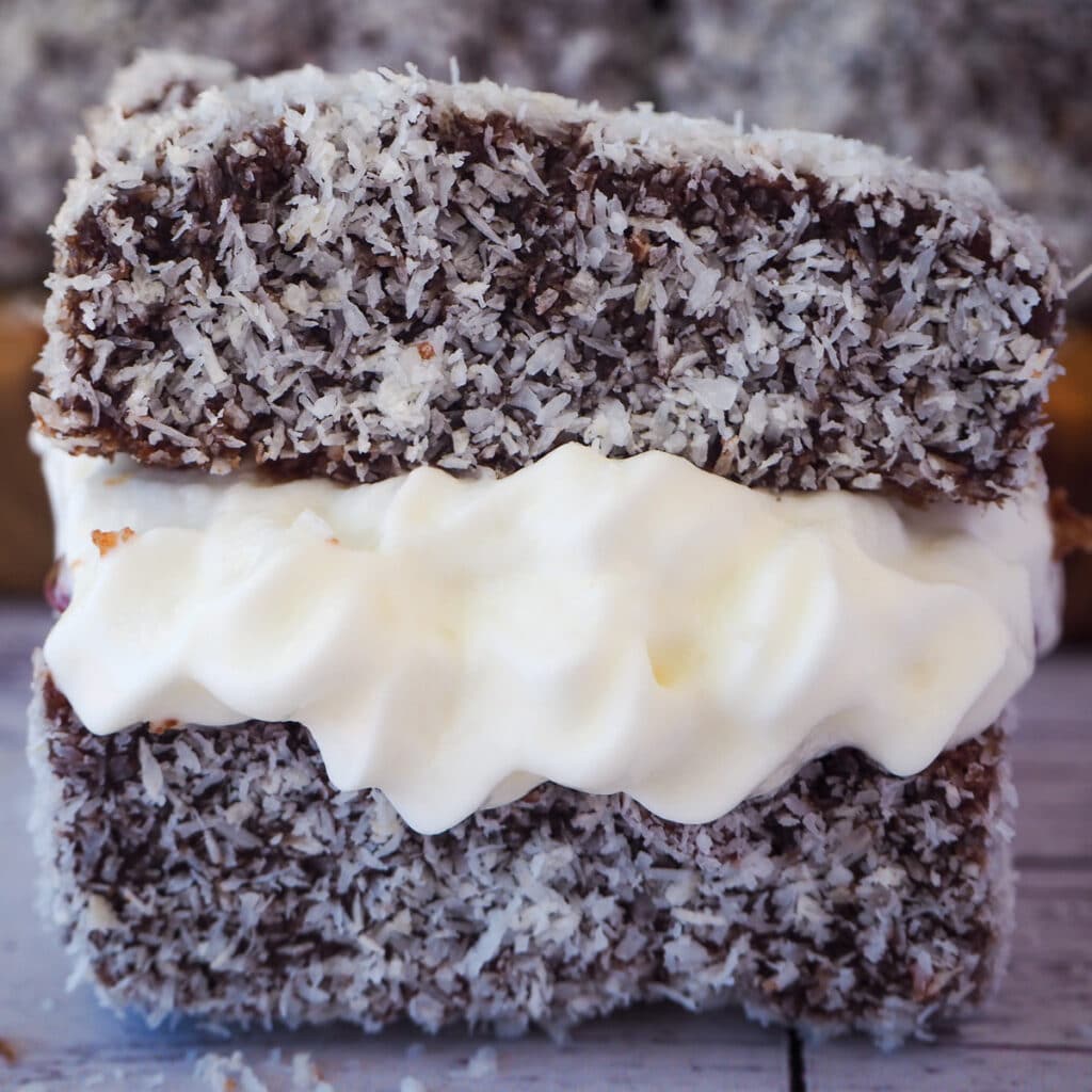 90 Dirt cheap meals 90 Close up lamington filled with jam and cream.