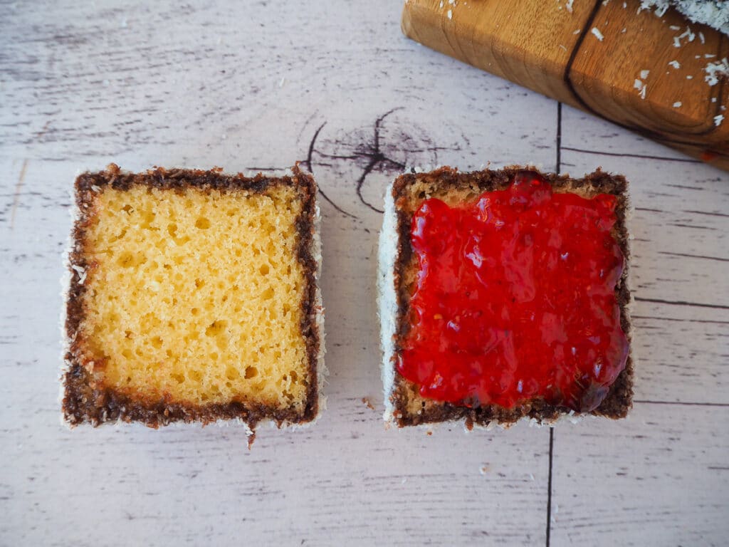 Lamingtons 35 Cut open lamington with jam on one side