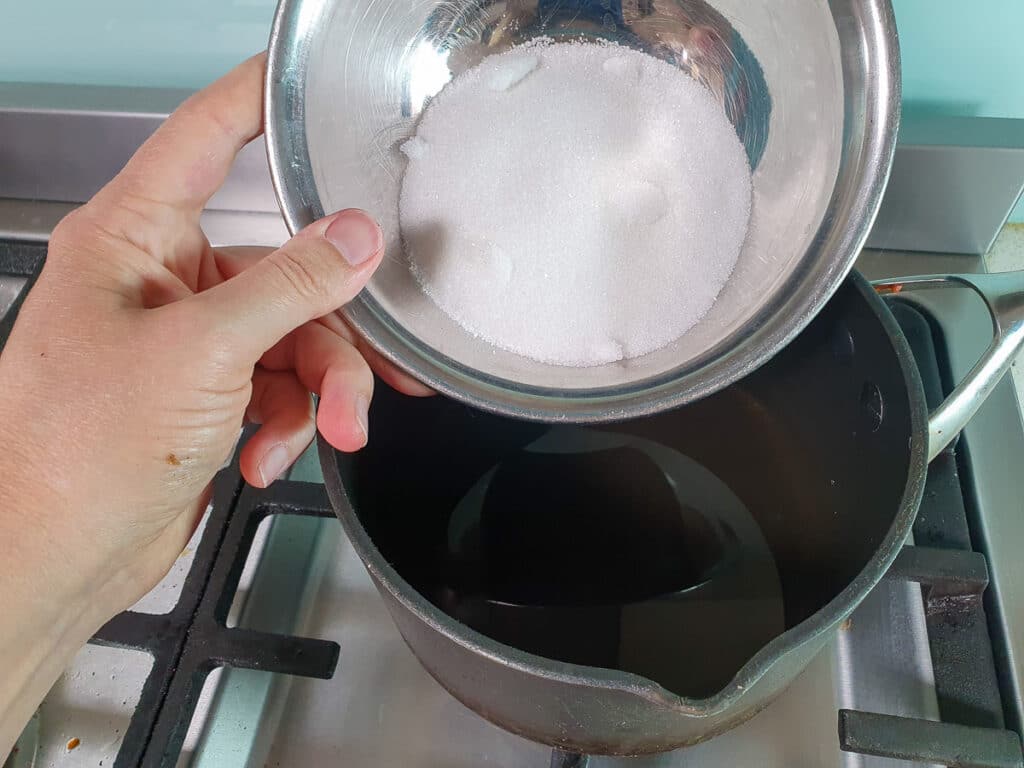 Refrigerator pickled beets 5 Adding sugar to pot on stove.