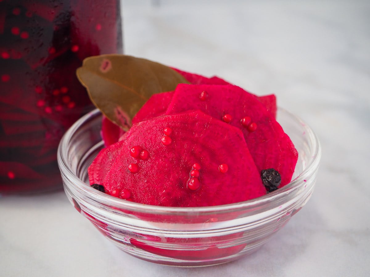 Refrigerator pickled beets 2 Close up refrigerator pickled beets in a small glass bowl, with a jar of pickled beets in the background.