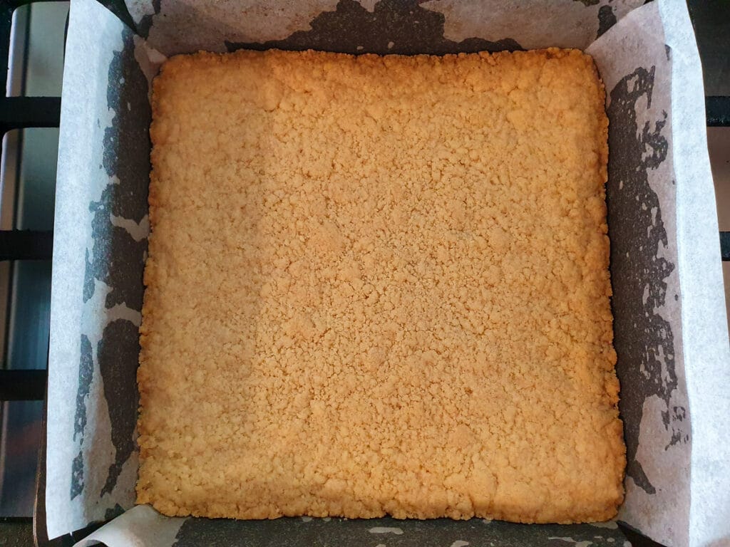 Ginger crunch 13 Cooked base ready to remove from oven, just starting to brown around the edges.