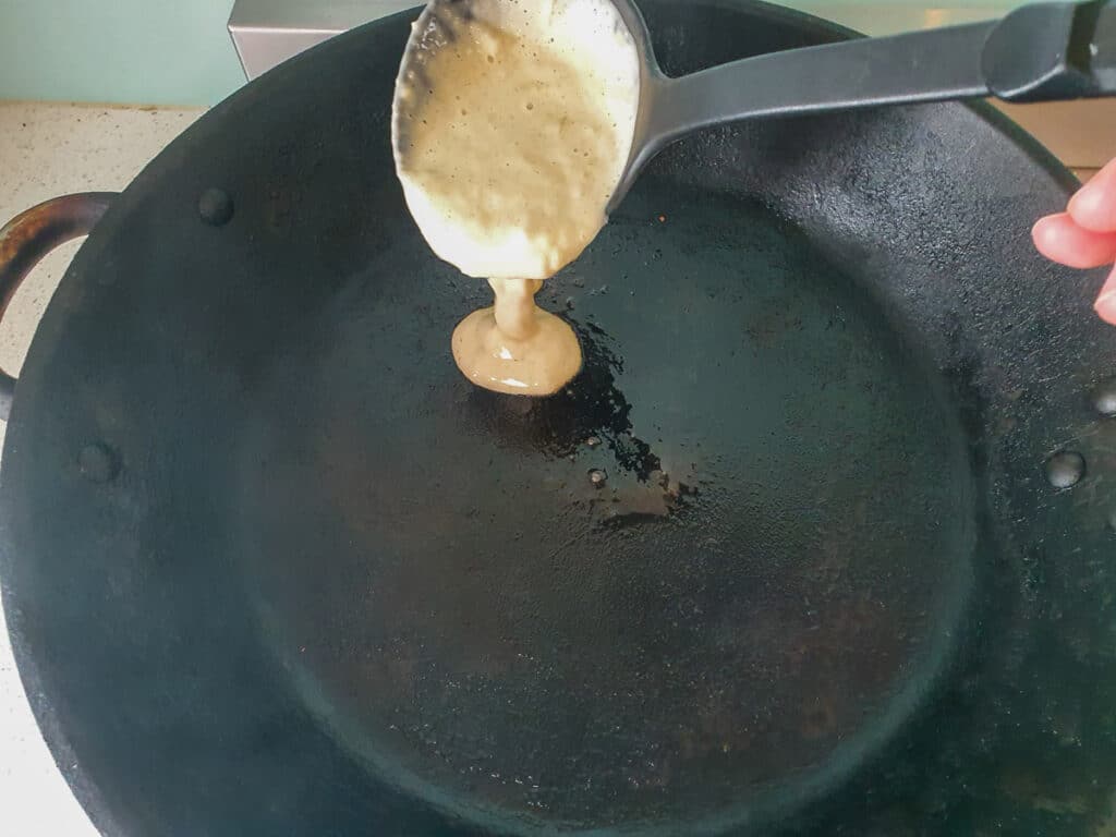 Banana pikelets 11 Ladling pikelet mix into hot frying pan.