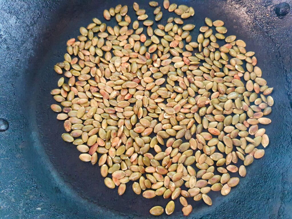Beetroot salad 4 Dry roasted pepitas in frying pan that are done.