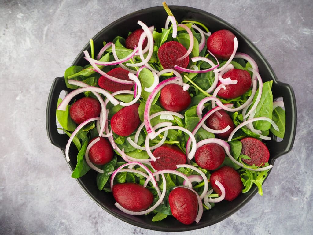 Beetroot salad 10 Adding finely sliced red onion to the salad.