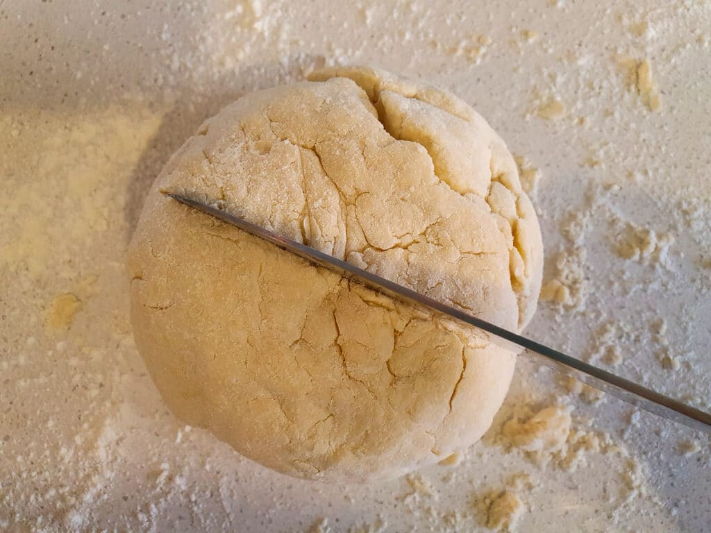 Damper 8 Cutting a shallow star in the top of the dough ball with a sharp knife.