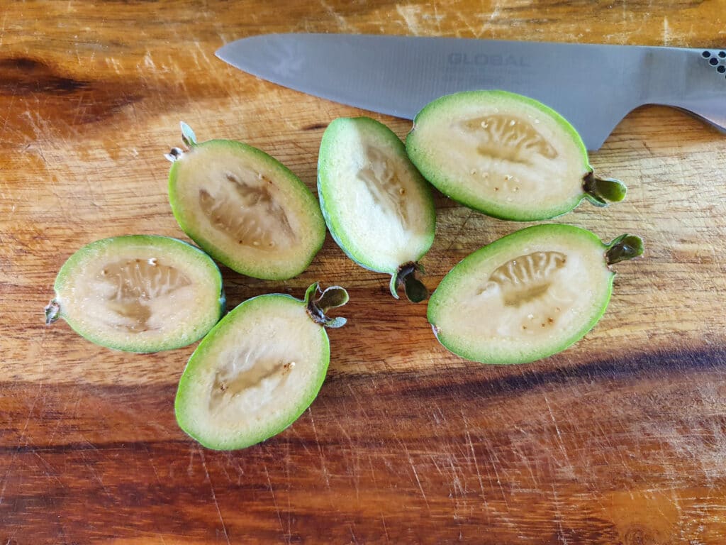 Feijoa muffins 4 Slicing feijoas in half length ways to scoop out flesh.