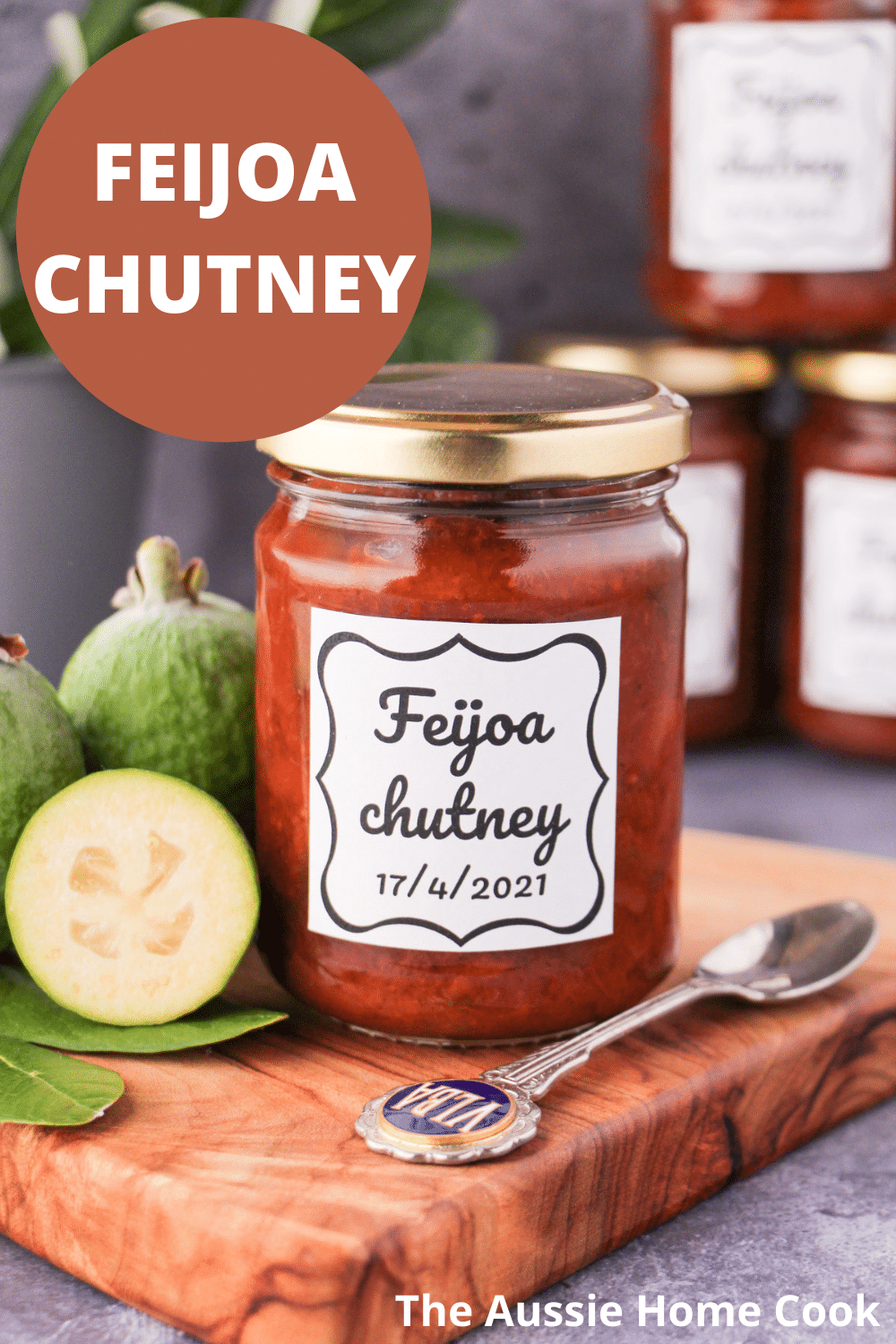 Feijoa chutney 19 Jar of homemade feijoa chutney on a board, with vintage spoon and fresh feijoas, stacked jars of chutney in the background, and text overlay, feijoa chutney, The Aussie Home Cook.
