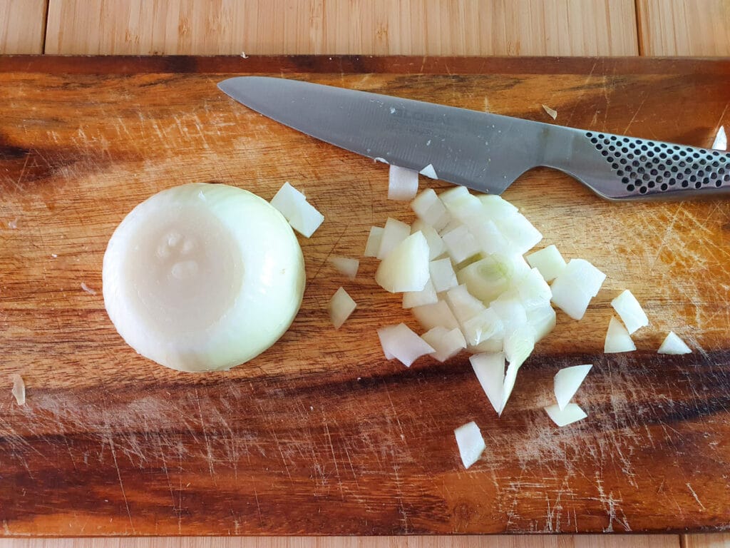 Feijoa chutney 6 Peeling and dicing brown onions.