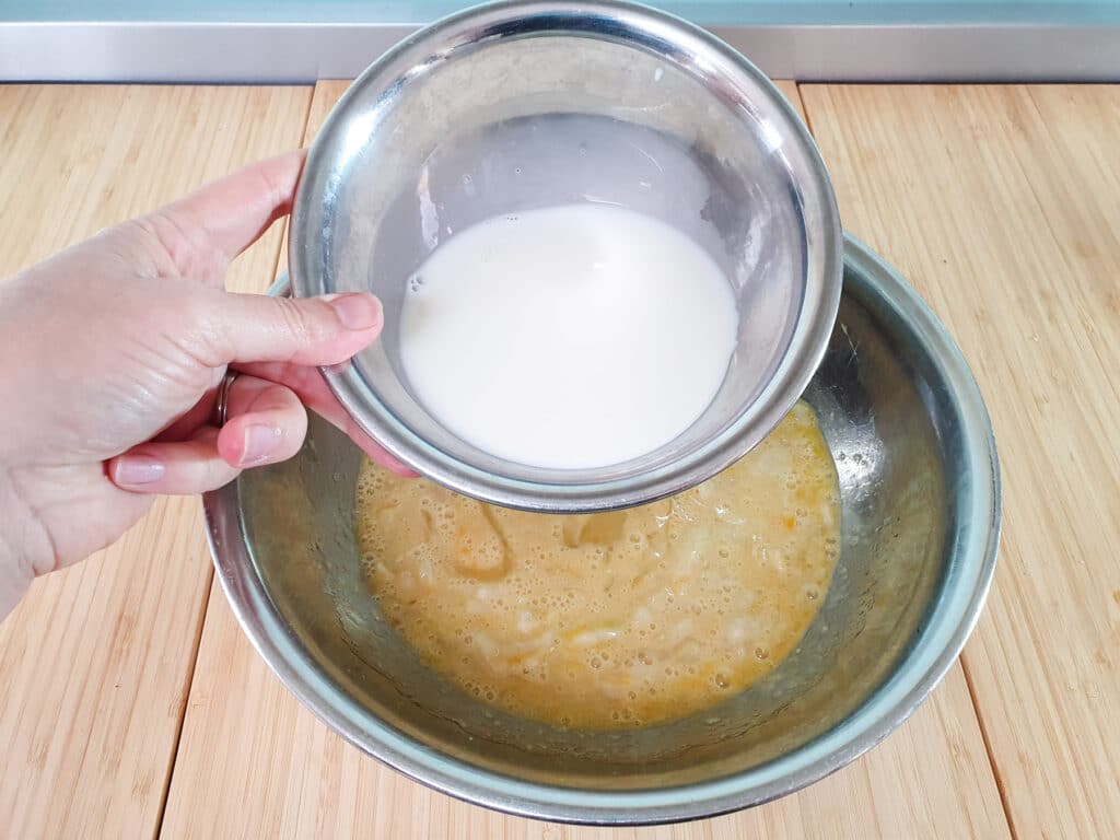 Adding milk to mashed feijoas.