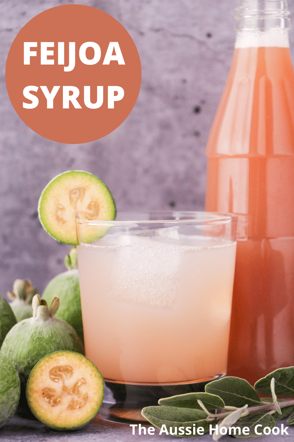 Feijoa syrup 13 Glass of made up feijoa syrup with ice and fresh feijoa garnish, with bottle of feijoa syrup and fresh feijoas and leaves, with text overlay, feijoa syrup and The Aussie Home Cook.