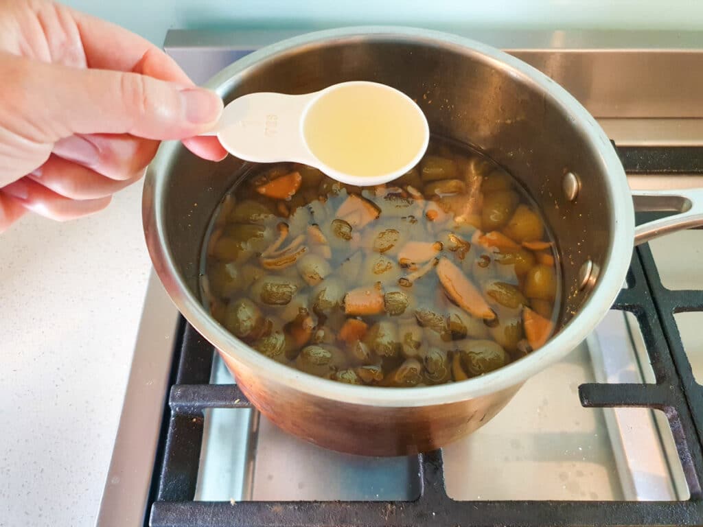 Feijoa syrup 8 Adding lemon juice to cooled syrup.
