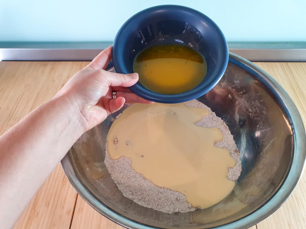 Pear muffins 10 Adding melted butter to muffin mix.