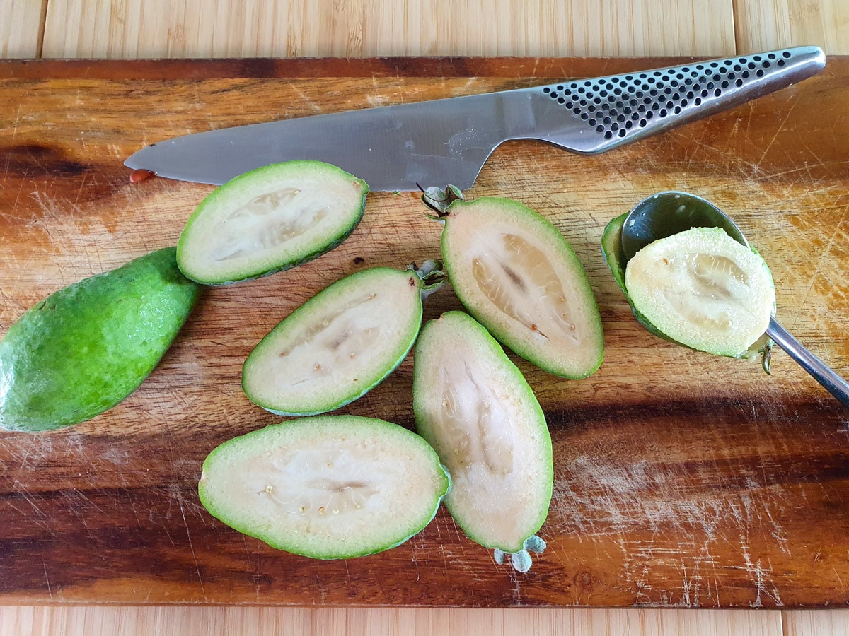 Feijoa recipes 6 Slicing open feijoas and scooping out flesh.