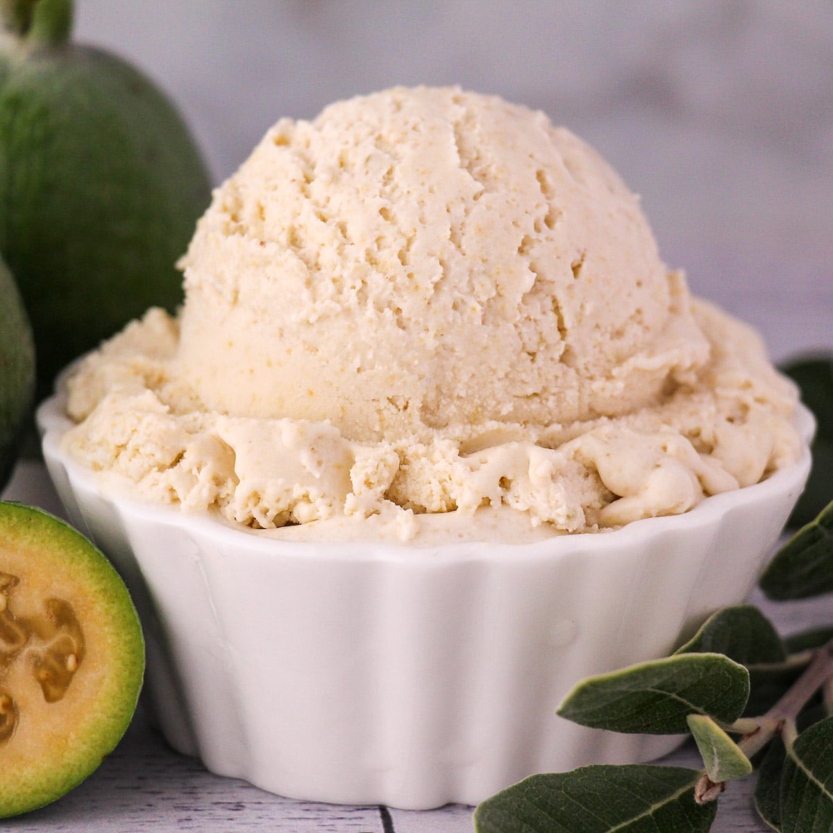 Feijoa recipes 21 Scoop of feijoa ice cream with fresh feijoa, vintage spoon and sprig of feijoa leaves.