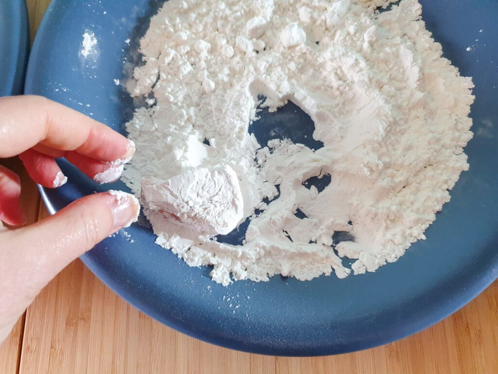 Chilli Chicken Gravy 14 Coating chicken in flour after egg wash.