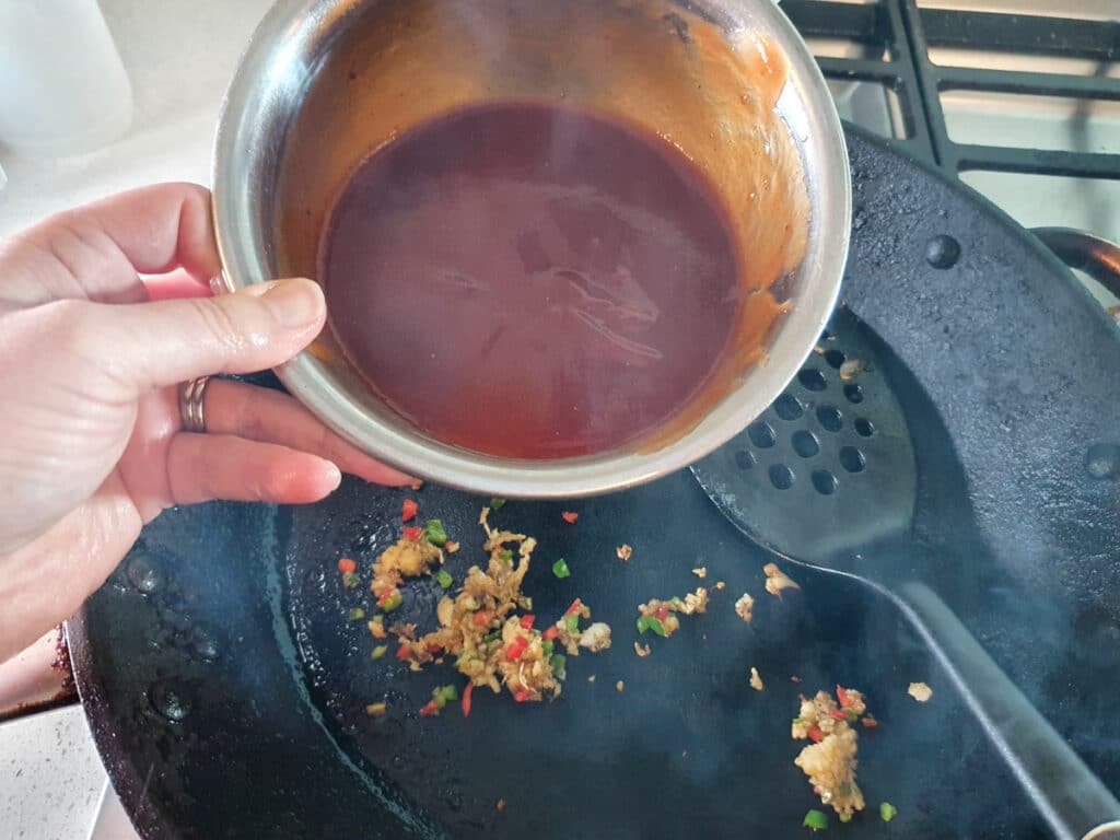 Chilli Chicken Gravy 18 Adding tomato sauce mix to the pan.