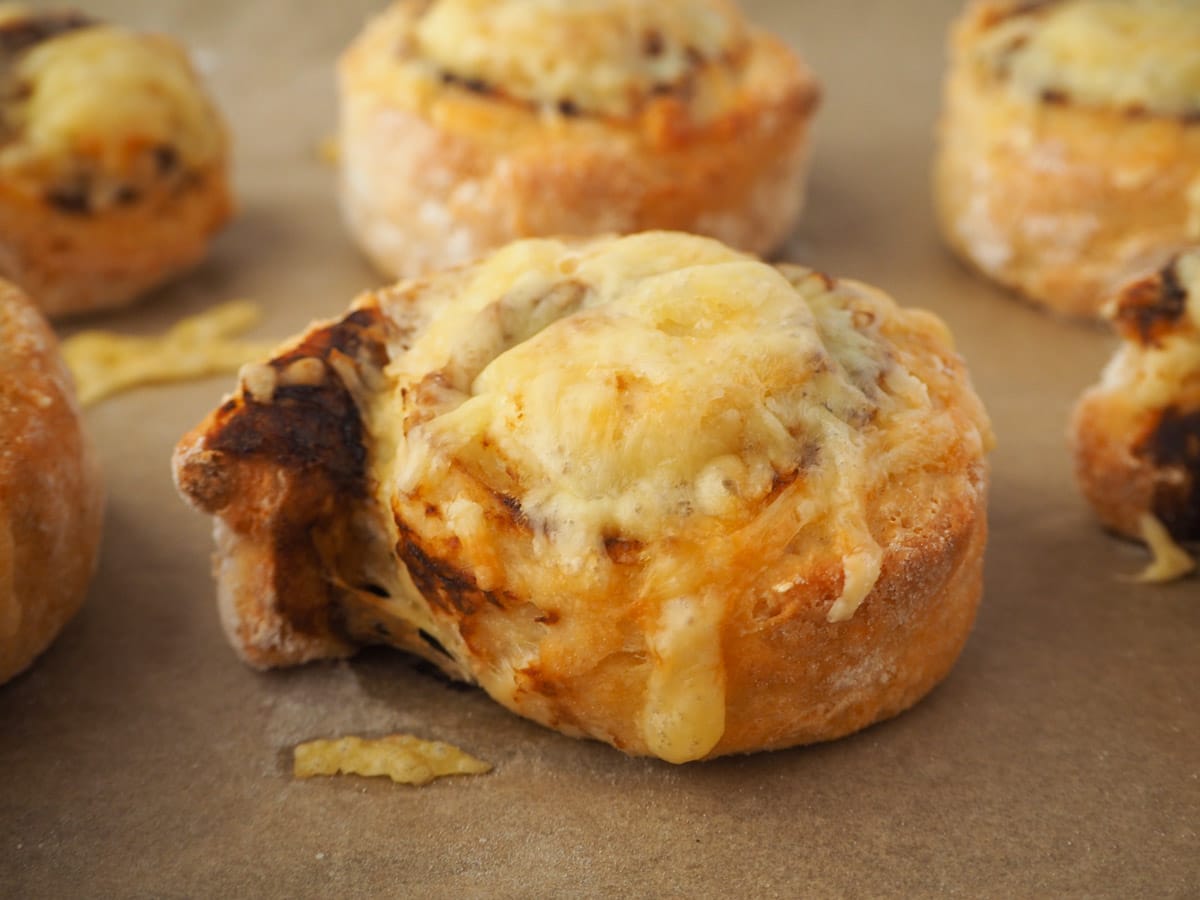 Cheesymite Scrolls 2 Scrolls on a baking tray.
