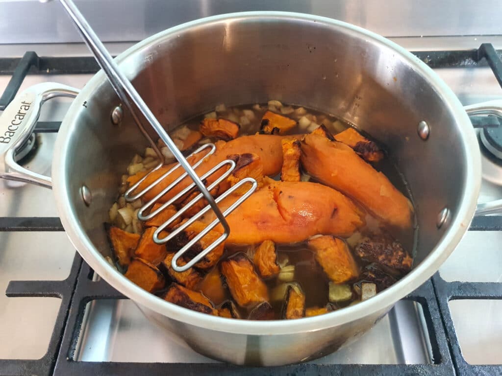 Pumpkin and Sweet Potato Soup 14 Mashing the soup.
