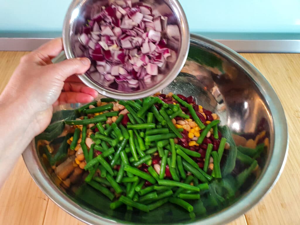 Four Bean Salad 10 Adding diced red onion.