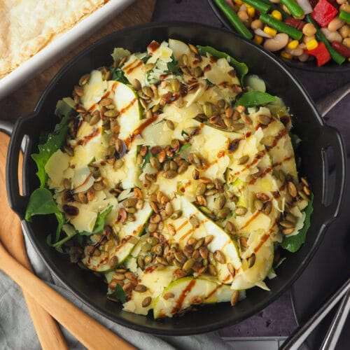 Rocket and Pear Salad 16 Close up salad with serving spoons, pie and four bean salad.