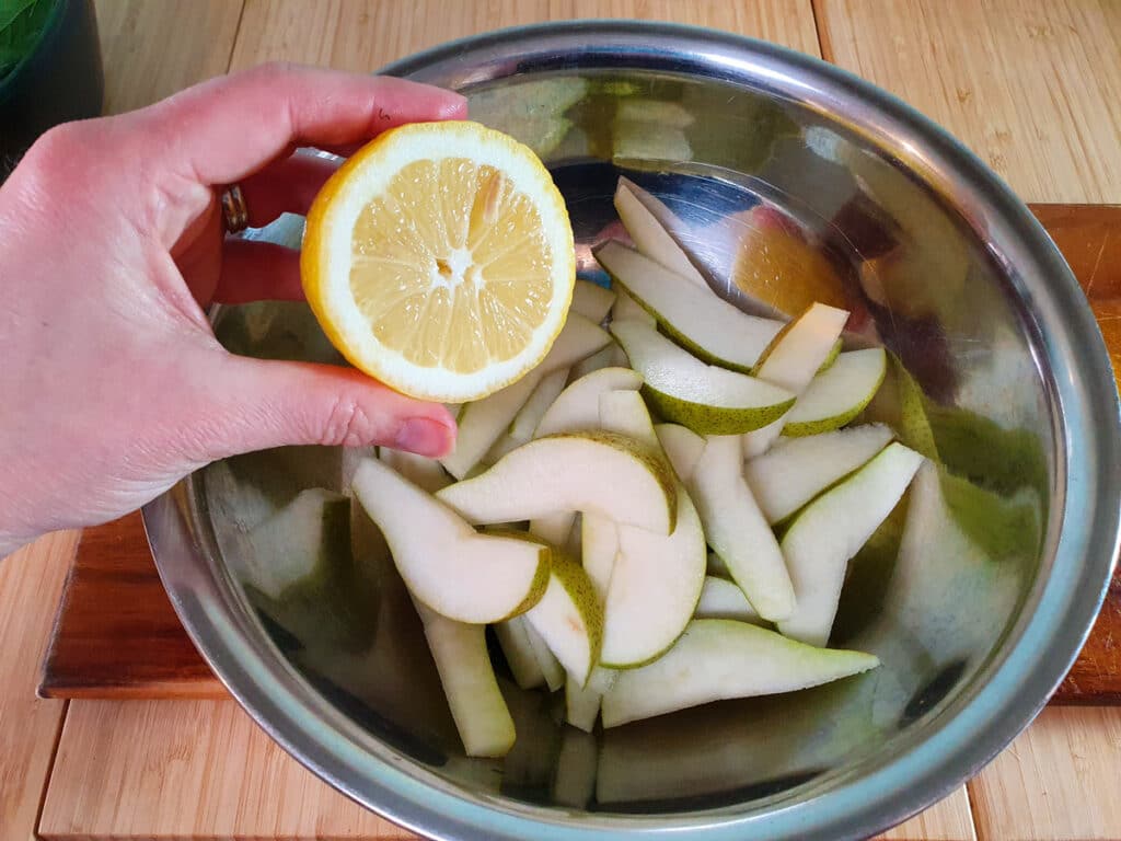Rocket and Pear Salad 6 Squeezing lemon juice over sliced pears.