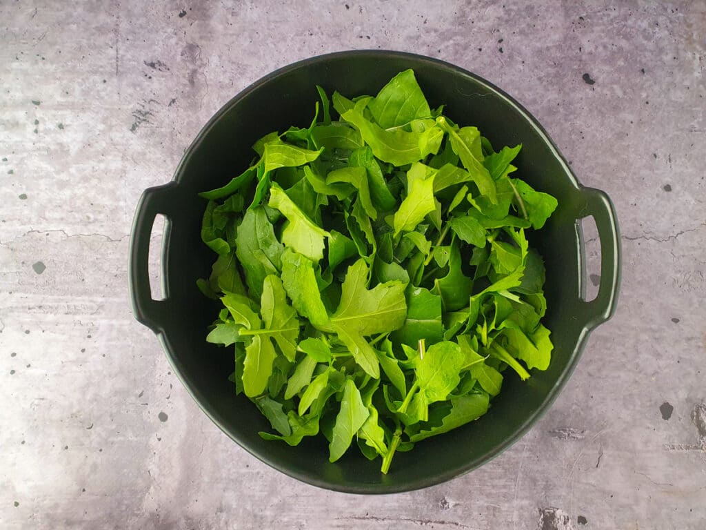Rocket and Pear Salad 7 Building salad, adding rocket.