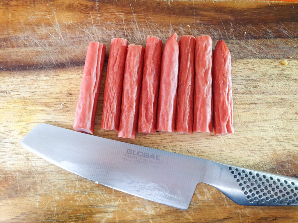 Picnic Charcuterie Board 7 Cutting twiggy sticks into bite sized pieces.