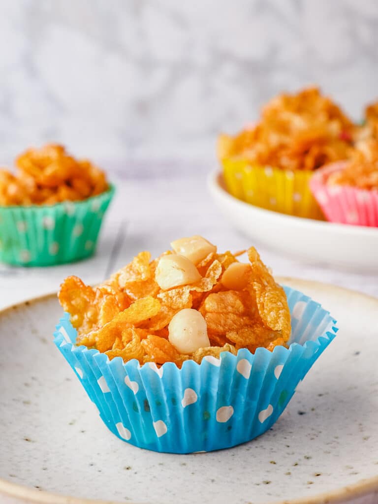 Honey Joys 12 Honey joy on a plate with honey joys in the background.