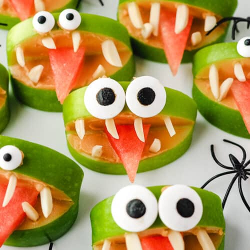 Apple Monsters 23 Close up apple monsters on a plate with toy spiders.