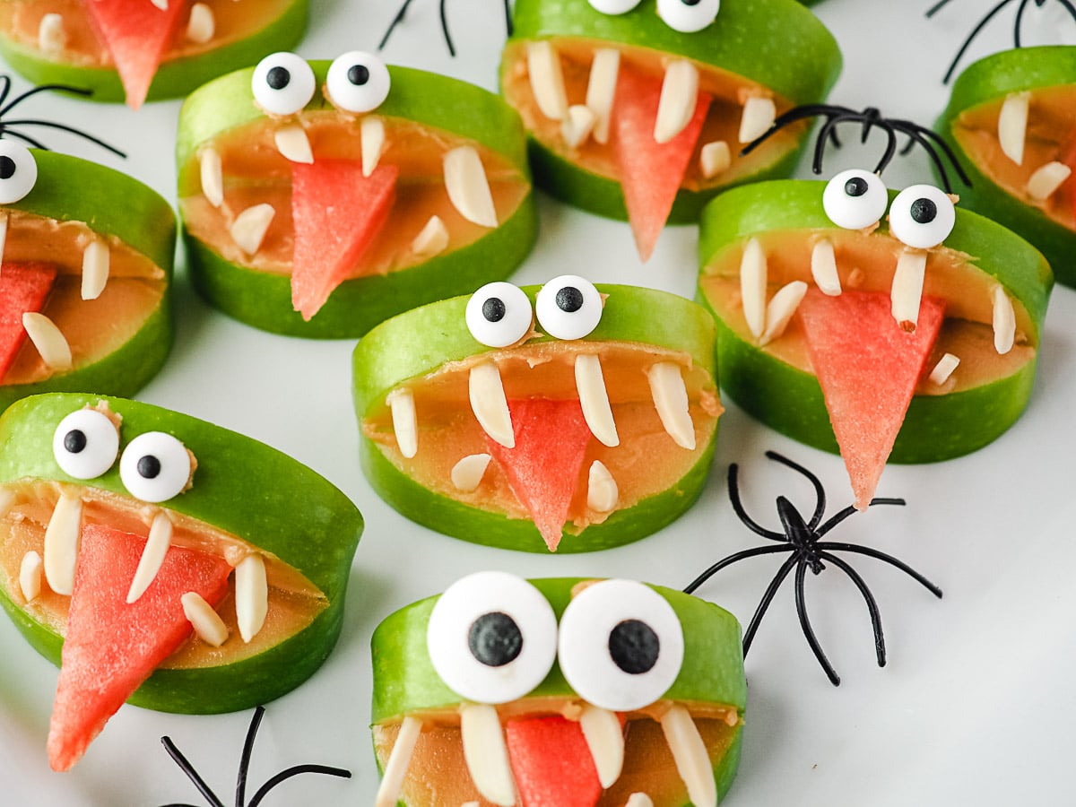 Apple Monsters 2 Close up apple monsters on a plate with toy spiders.