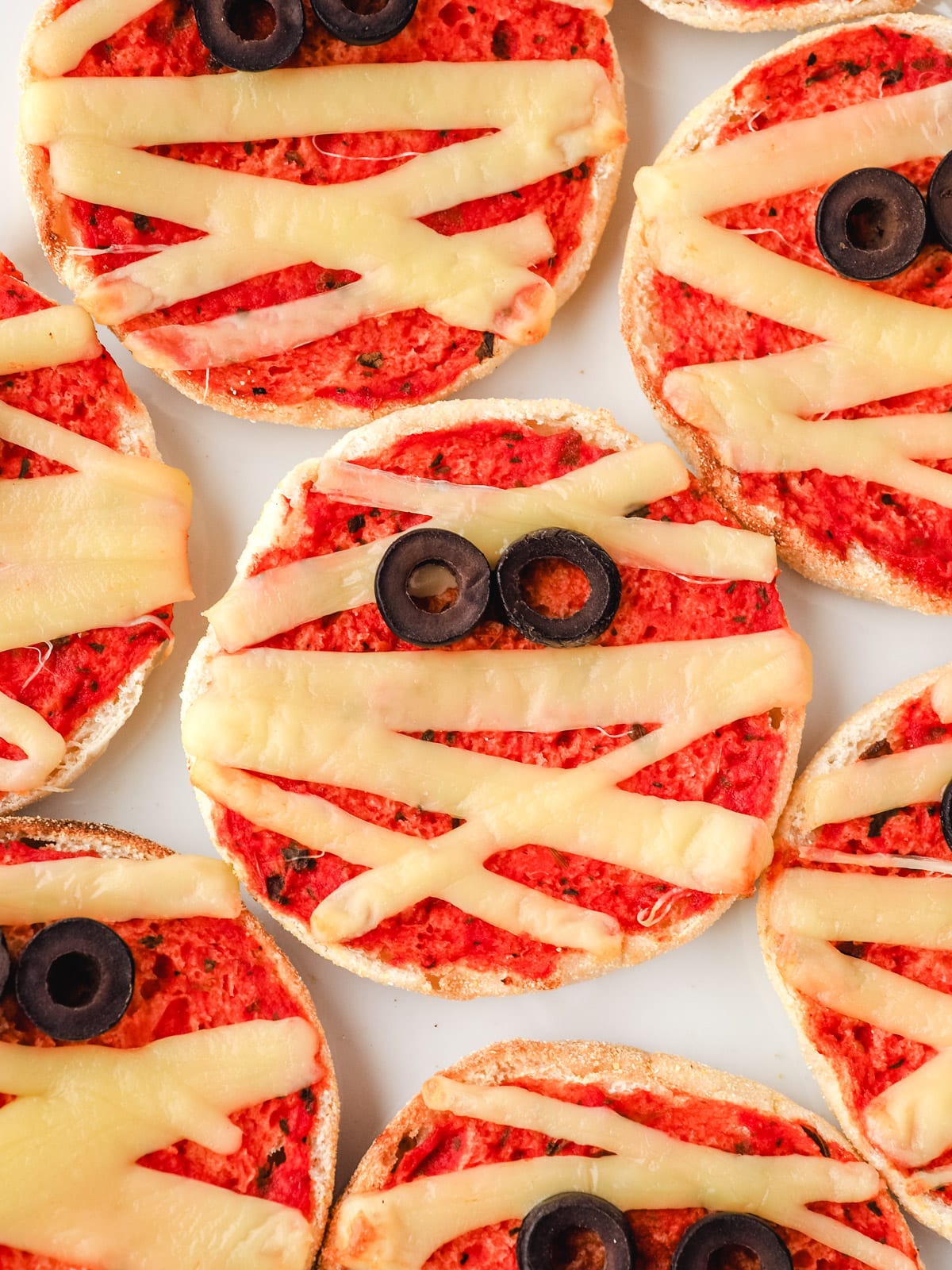 Mummy Pizzas 10 Top down view of mummy pizzas on a plate.