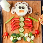 Skeleton Veggie Tray 8 Close up veggie tray on a board with Halloween skuls and spiders.