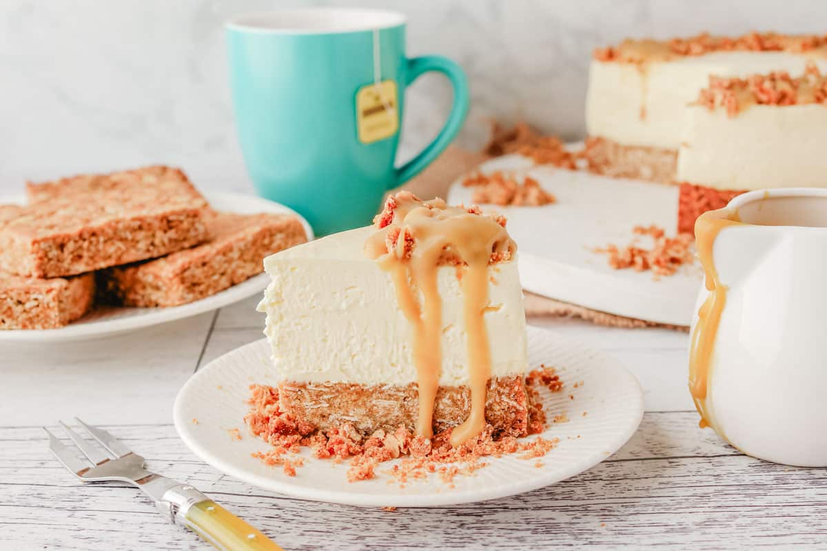 Anzac Cheesecake 9 Slice of Anzac cheesecake with Anzac slice and rest of cheesecake in the background.